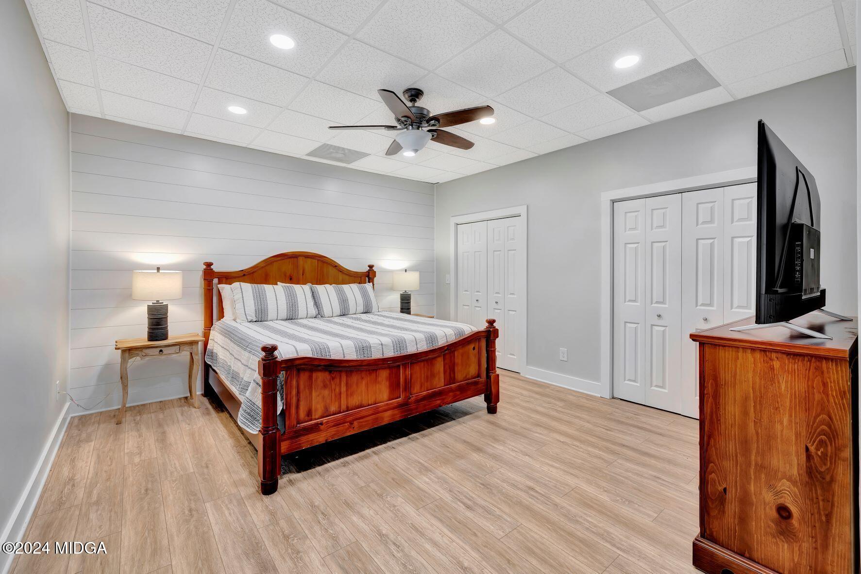 475 Brent Road Barnesville, GA 30204 - Photo 80 of 132 a living room with a bed furniture flat screen tv and a dresser with wooden floor