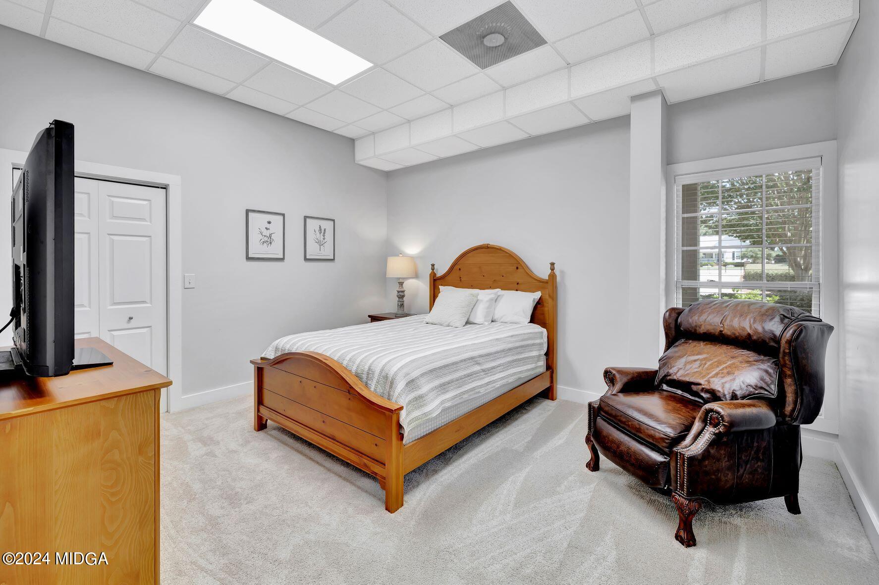 475 Brent Road Barnesville, GA 30204 - Photo 87 of 132 a bedroom with a bed and a flat screen tv