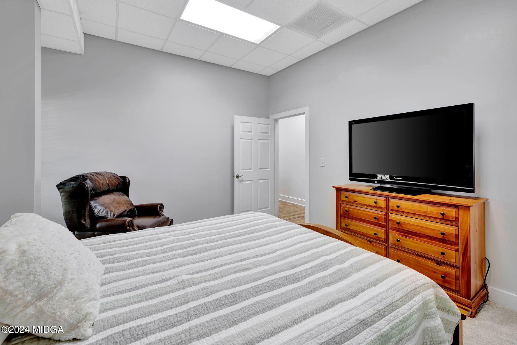 475 Brent Road Barnesville, GA 30204 - Photo 88 of 132 a bedroom with a bed and a flat screen tv