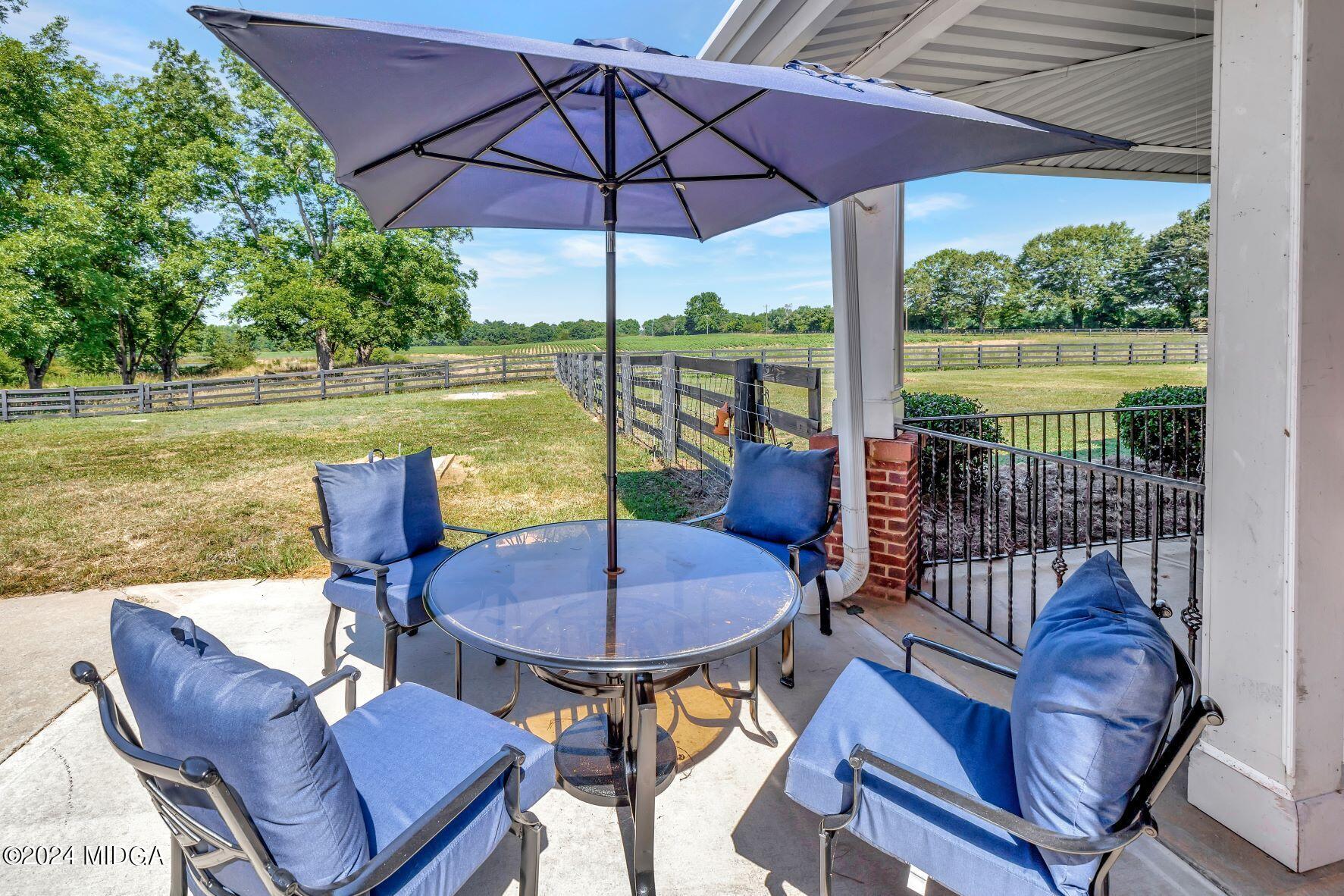 475 Brent Road Barnesville, GA 30204 - Photo 95 of 132 a view of a patio with a table chairs and a umbrella