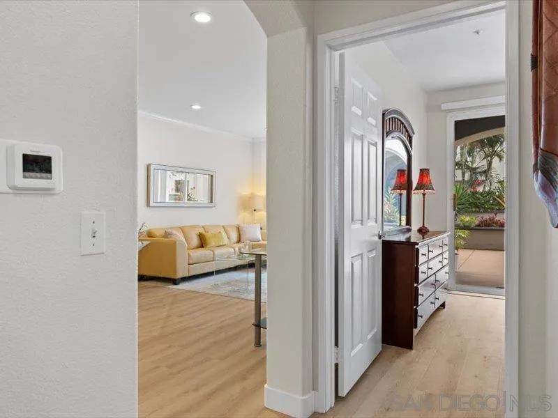 9237 Regents Road, Unit K101 La Jolla, CA 92037 - Photo 10 of 29 a bedroom with furniture and a wooden floor