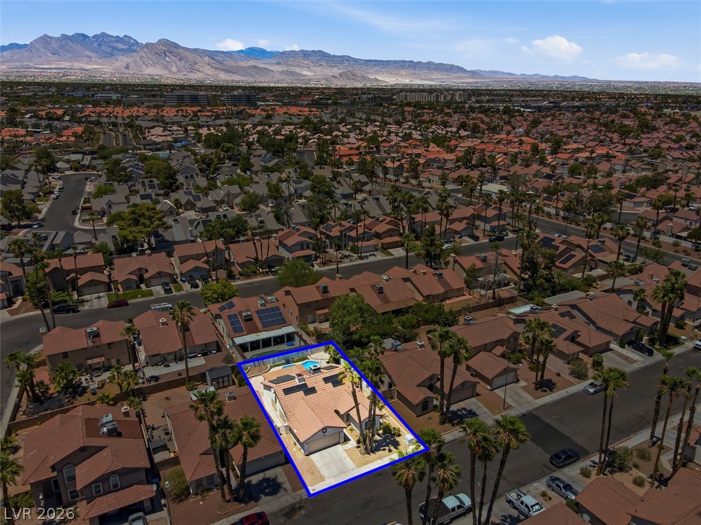 2609 Shakespeare Road Las Vegas, NV 89108 - Photo 39 of 41 An aerial perspective showcases the inviting private pool and surrounding residential community with distant mountain vistas.