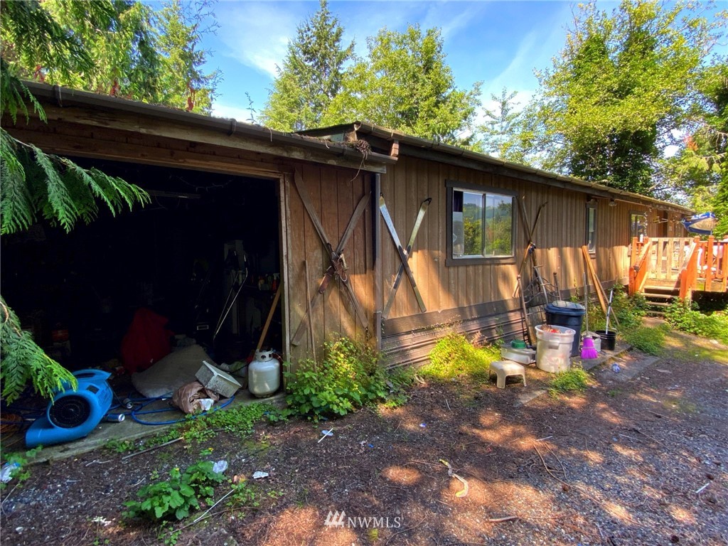 3793 East Smith Road Bellingham, WA 98226 - Photo 10 of 14 a view of a backyard with a table and chairs under an umbrella