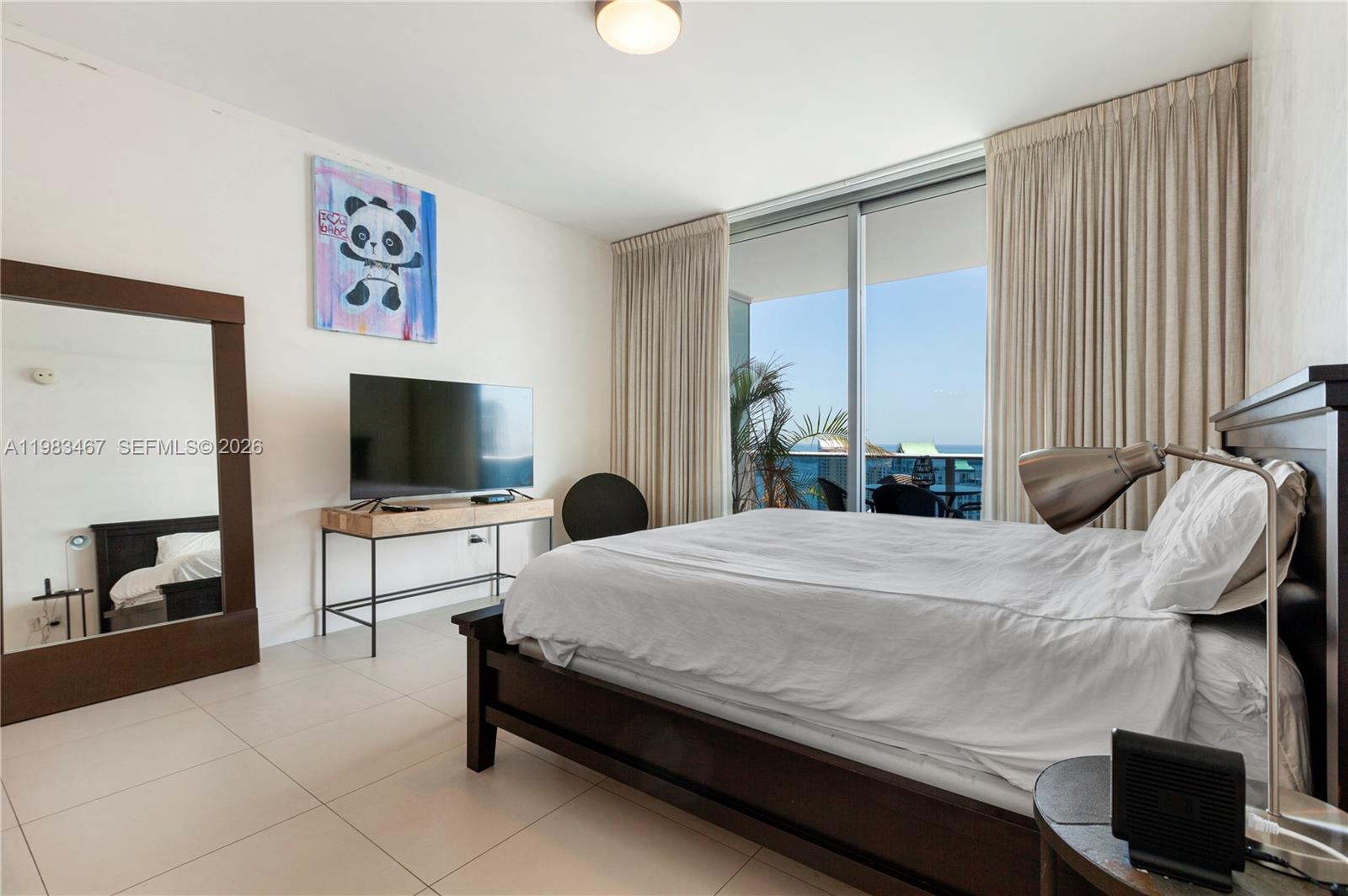 200 Biscayne Blvd Way, Unit 4907 Miami, FL 33131 - Photo 11 of 18 a bedroom with a bed and a flat screen tv