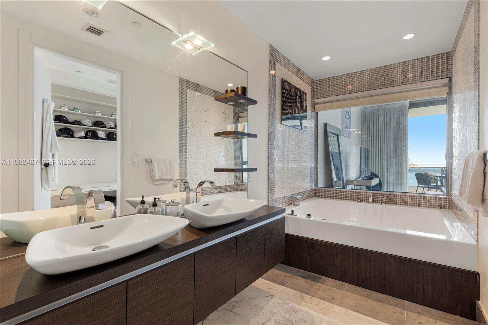 200 Biscayne Blvd Way, Unit 4907 Miami, FL 33131 - Photo 13 of 18 a bathroom with a double vanity sink mirror and double