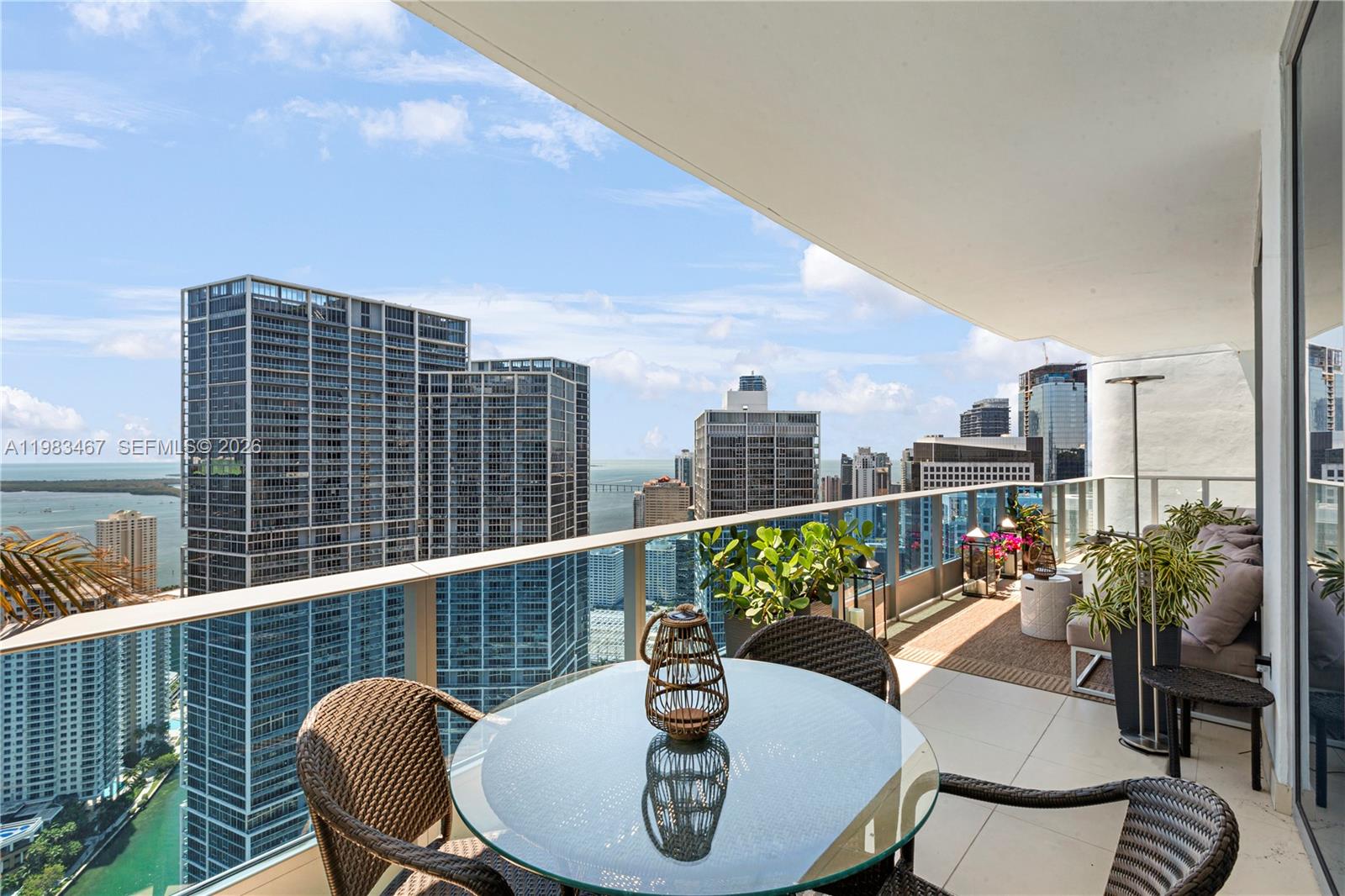 200 Biscayne Blvd Way, Unit 4907 Miami, FL 33131 - Photo 14 of 18 a balcony with table and chairs