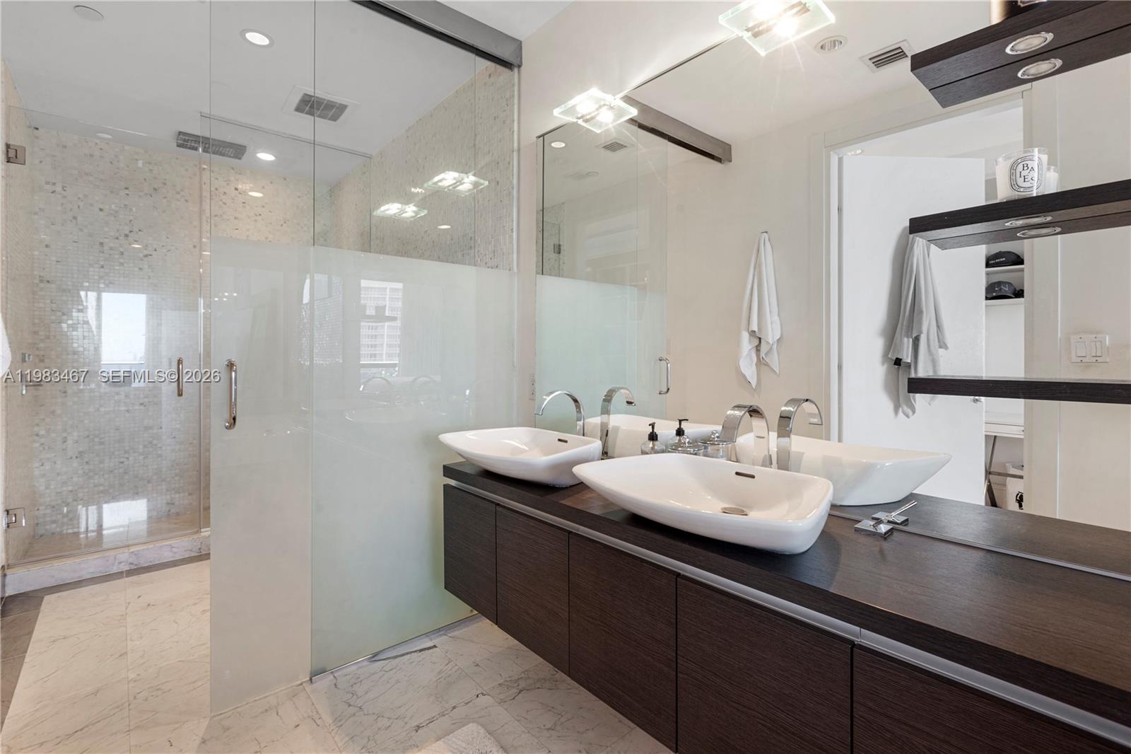 200 Biscayne Blvd Way, Unit 4907 Miami, FL 33131 - Photo 17 of 18 a bathroom with a sink double vanity and a mirror