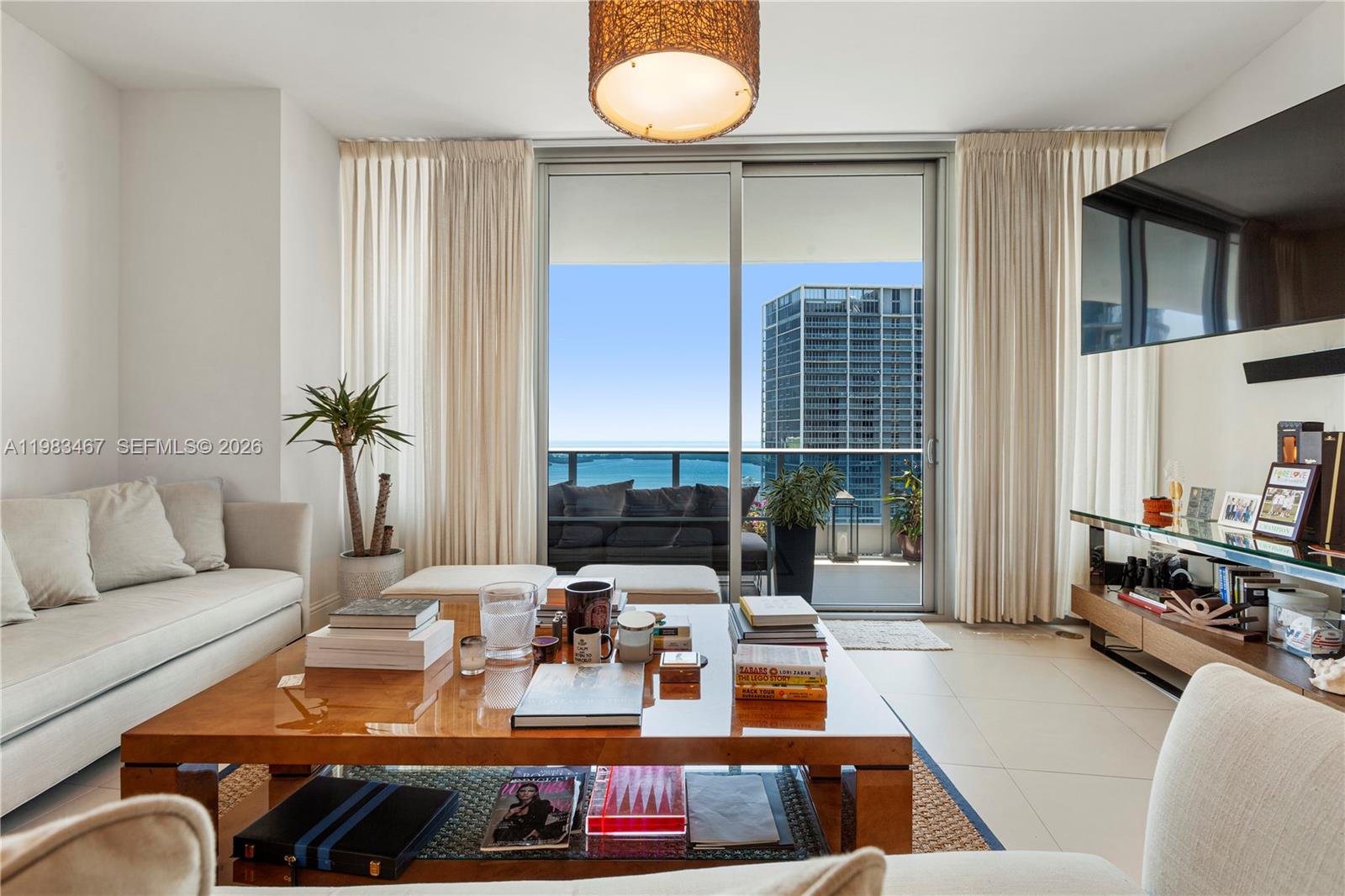 200 Biscayne Blvd Way, Unit 4907 Miami, FL 33131 - Photo 7 of 18 a living room with furniture fireplace and a large window