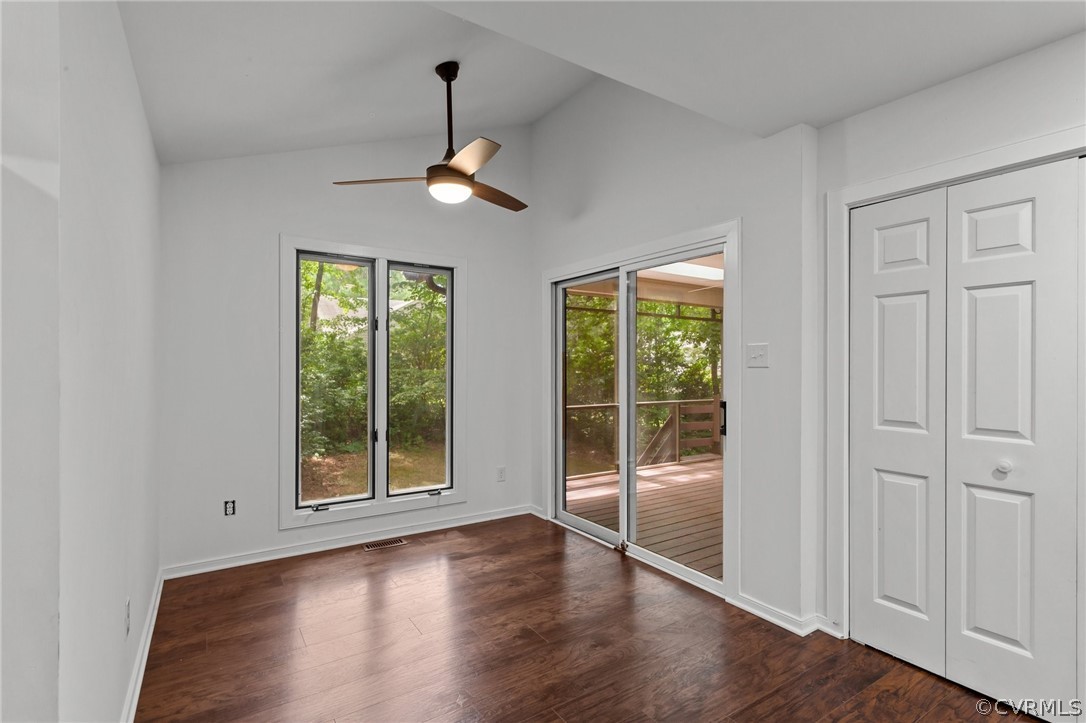 14307 Spring Gate Road Midlothian, VA 23112 - Photo 18 of 39 an empty room with wooden floor cabinet and windows