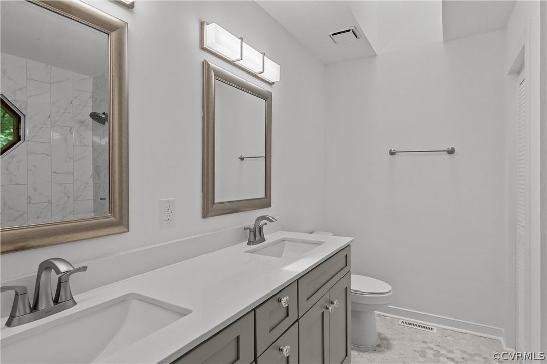 14307 Spring Gate Road Midlothian, VA 23112 - Photo 22 of 39 a bathroom with a sink toilet and mirror