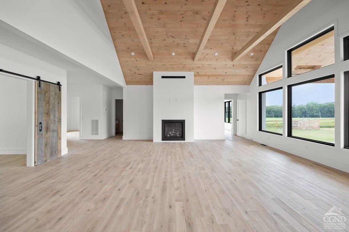 49 Snyder Pond Road Copake, NY 12516 - Photo 12 of 25 a view of empty room with wooden floor and fireplace