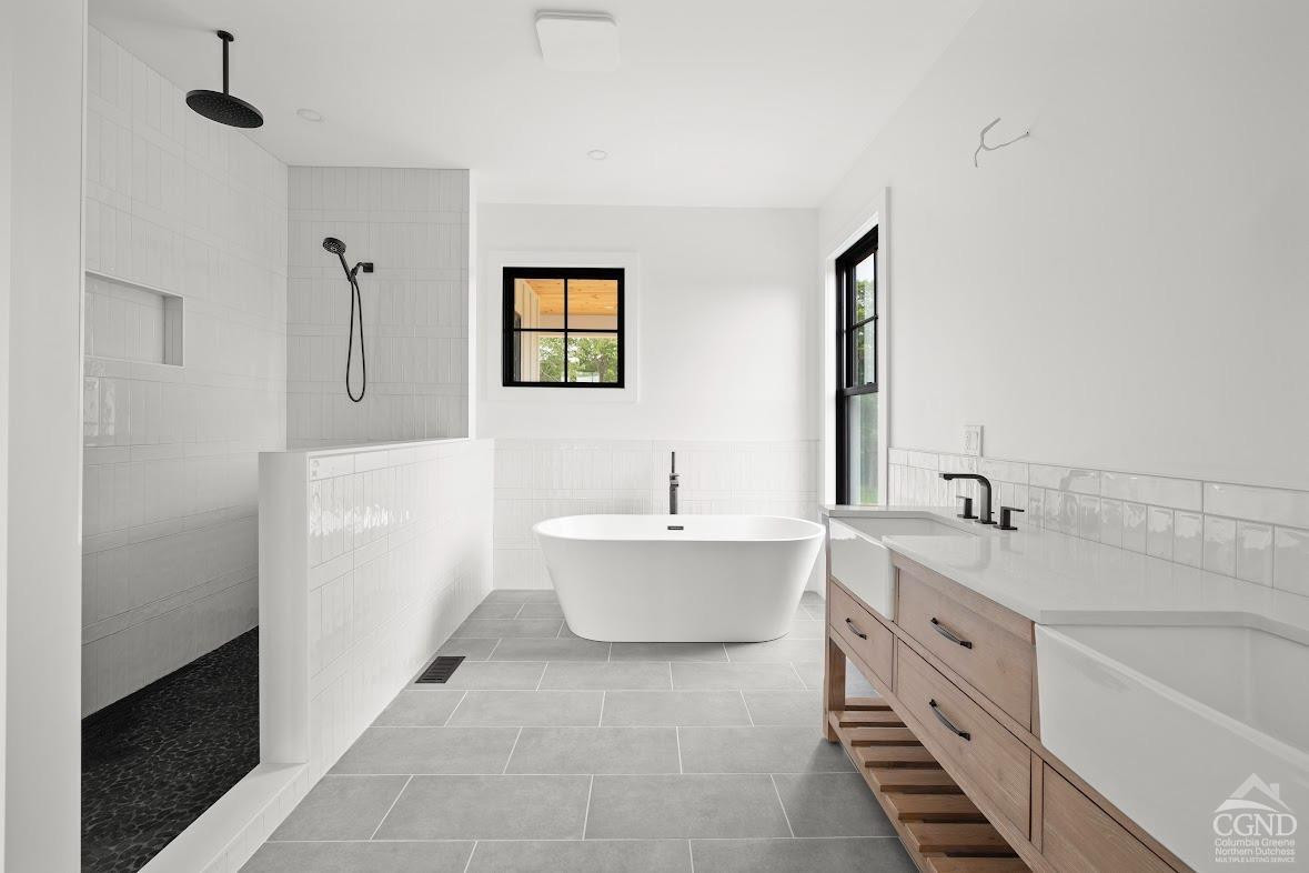 49 Snyder Pond Road Copake, NY 12516 - Photo 14 of 25 a spacious bathroom with a bathtub sink and toilet