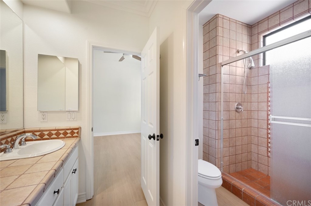 3724 Cedar Vale Way Fallbrook, CA 92028 - Photo 22 of 39 a bathroom with a granite countertop sink toilet and shower