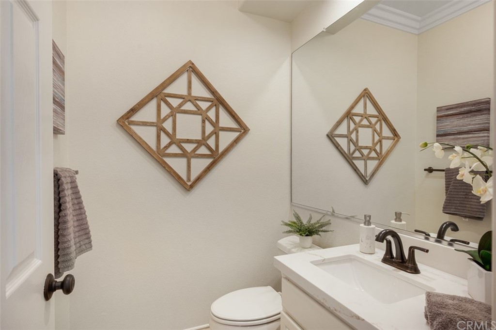 3724 Cedar Vale Way Fallbrook, CA 92028 - Photo 24 of 39 a bathroom with a toilet sink and mirror
