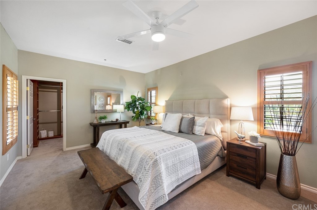 3724 Cedar Vale Way Fallbrook, CA 92028 - Photo 33 of 39 a bedroom with a large bed and a chandelier fan