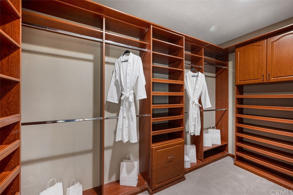 3724 Cedar Vale Way Fallbrook, CA 92028 - Photo 35 of 39 a view of walk in closet with clothes and shoes