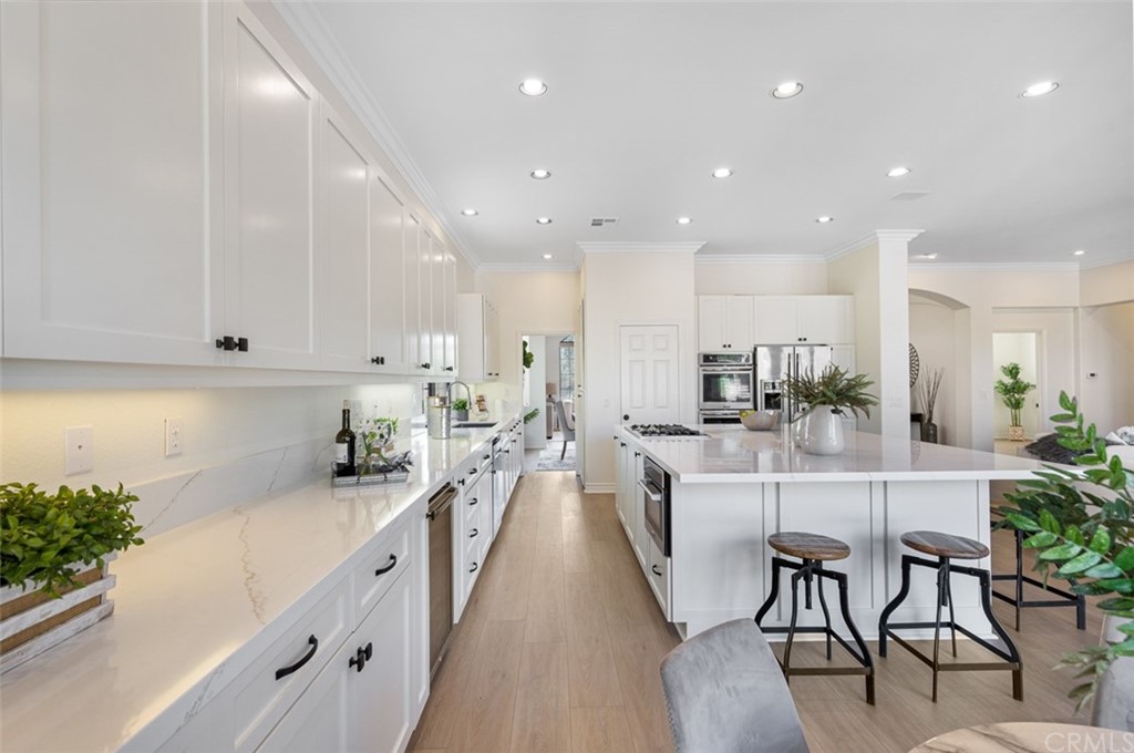 3724 Cedar Vale Way Fallbrook, CA 92028 - Photo 8 of 39 a view of a kitchen with kitchen island and stainless steel appliances