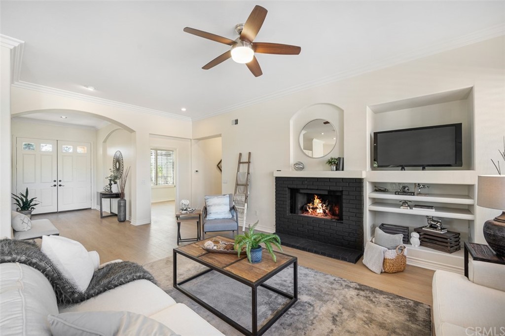 3724 Cedar Vale Way Fallbrook, CA 92028 - Photo 9 of 39 a living room with furniture a fireplace and a flat screen tv