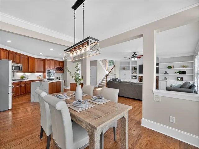 a view of a dining room with furniture and wooden floor