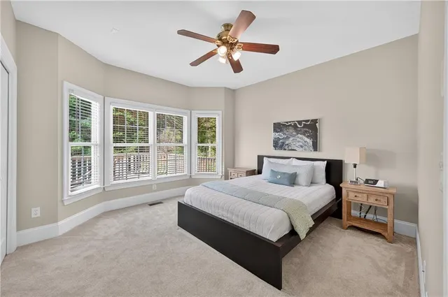 a spacious bedroom with a bed and a large window