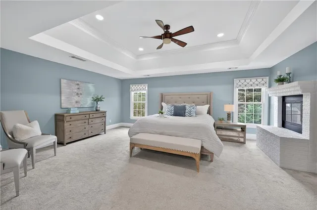 a bedroom with a bed a couch and a window