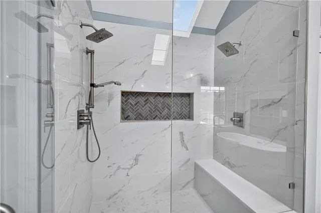 a bathroom with a bath tub and shower