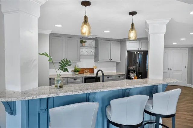 a kitchen with stainless steel appliances a sink a table and chairs
