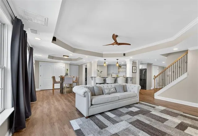 a living room with furniture and a ceiling fan