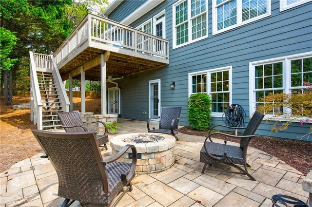 a view of a patio with couple of chairs and a table and chairs
