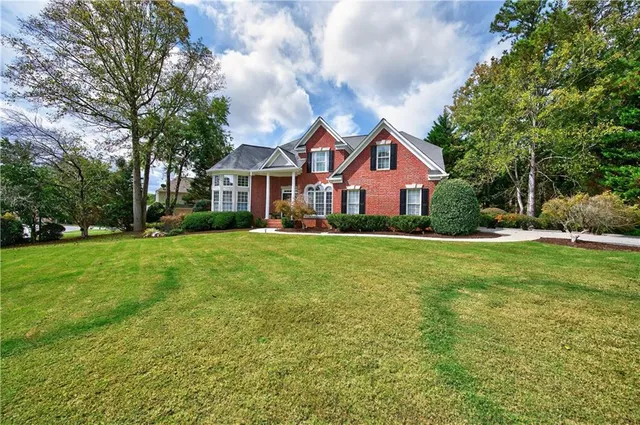 a front view of a house with a yard