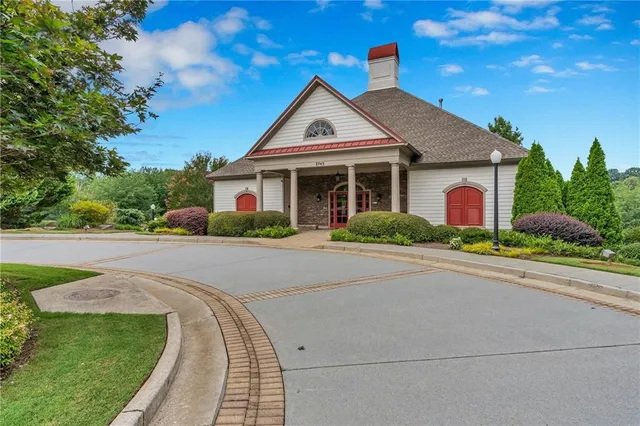 a view of backyard with wooden fence and a large tree