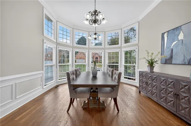 a view of a dining room with furniture window and wooden floor