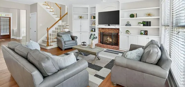a living room with furniture fireplace and flat screen tv