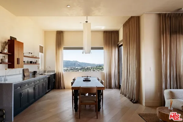 a kitchen with stainless steel appliances granite countertop a refrigerator and a stove