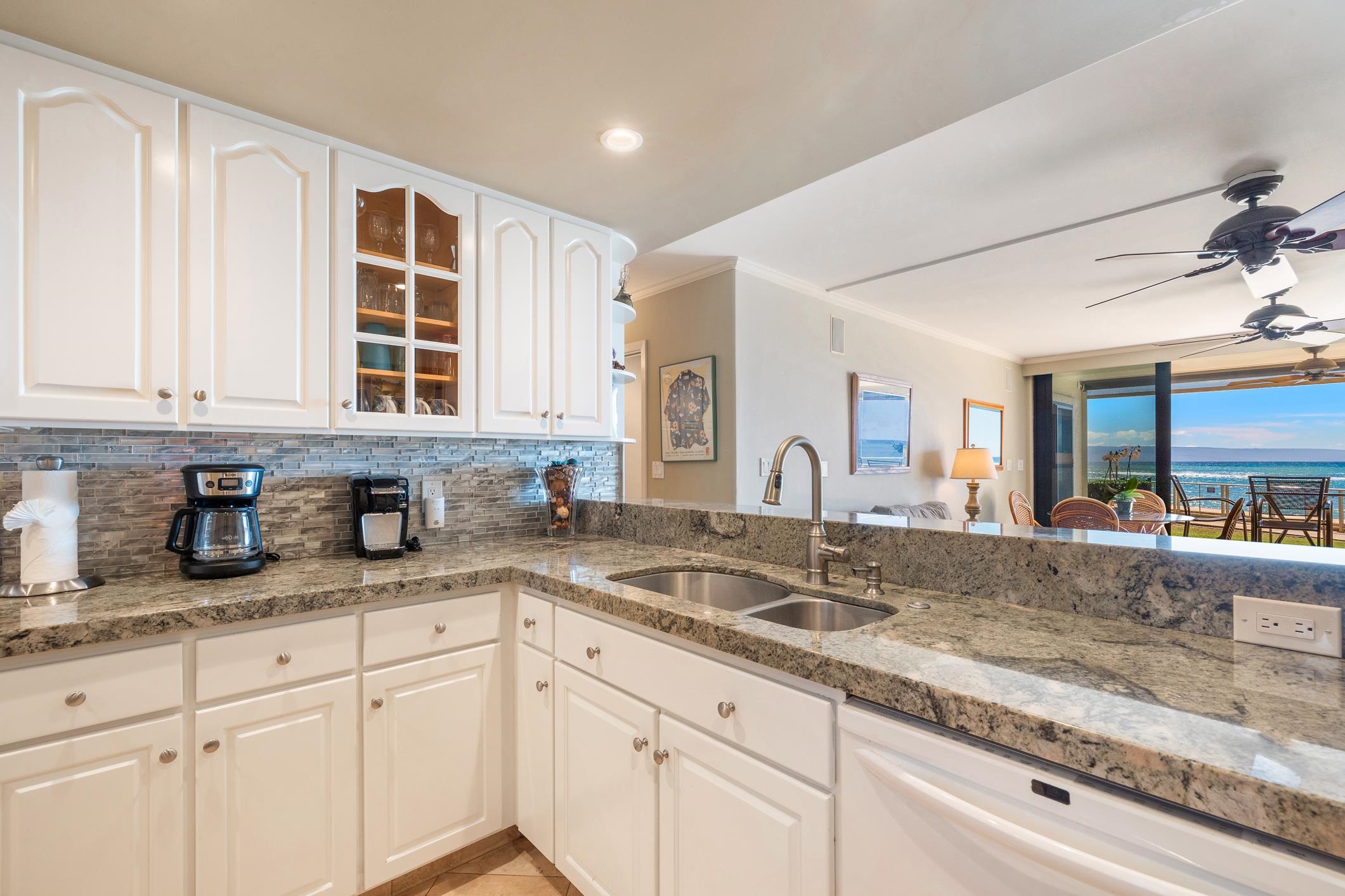 4401 Lower Honoapiilani Road, Unit A103 Lahaina, HI 96761 - Photo 2 of 45 a kitchen with granite countertop a sink and cabinets