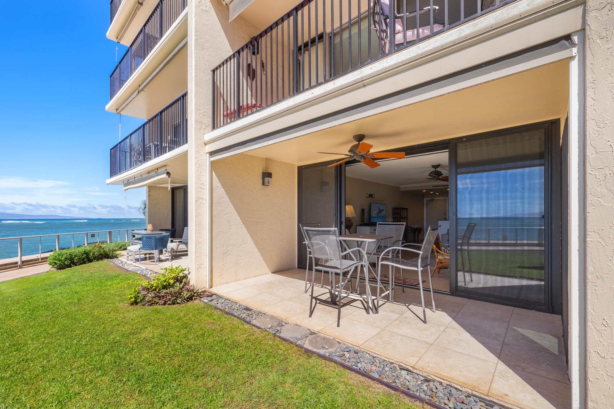 4401 Lower Honoapiilani Road, Unit A103 Lahaina, HI 96761 - Photo 24 of 45 a view of a patio with table and chairs near a barn