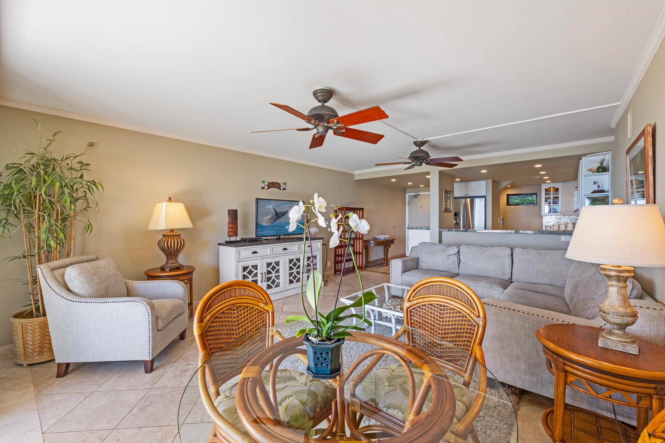 4401 Lower Honoapiilani Road, Unit A103 Lahaina, HI 96761 - Photo 29 of 45 a living room with furniture a fireplace and a chandelier