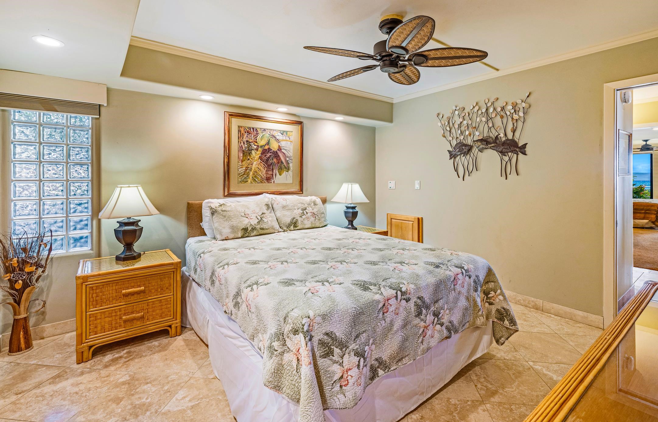 4401 Lower Honoapiilani Road, Unit A103 Lahaina, HI 96761 - Photo 42 of 45 a bedroom with a bed and a painting on the wall