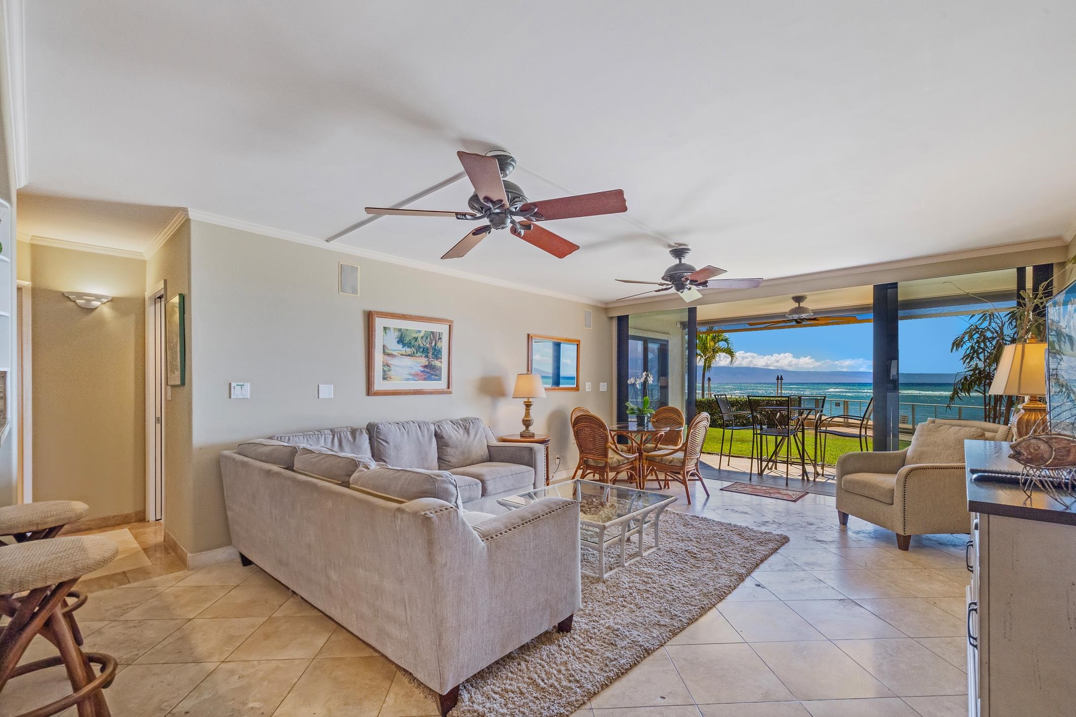 4401 Lower Honoapiilani Road, Unit A103 Lahaina, HI 96761 - Photo 5 of 45 a living room with furniture a ceiling fan and a window