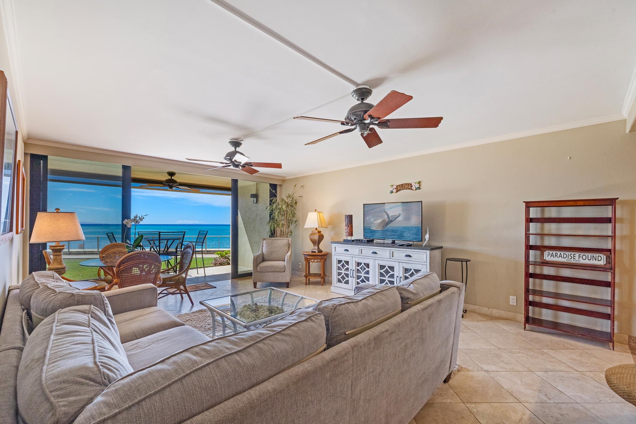 4401 Lower Honoapiilani Road, Unit A103 Lahaina, HI 96761 - Photo 6 of 45 a living room with furniture and a ceiling fan