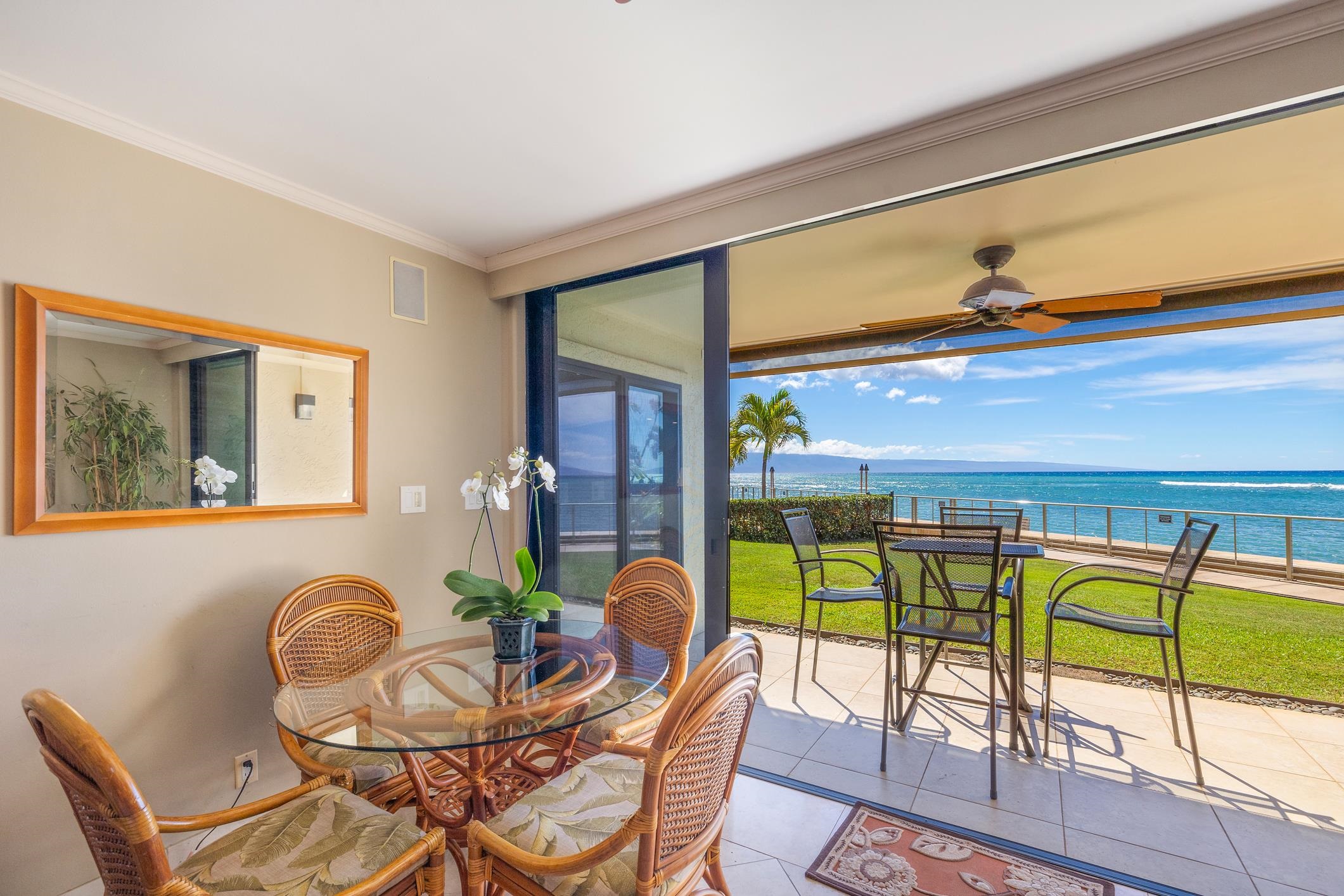 4401 Lower Honoapiilani Road, Unit A103 Lahaina, HI 96761 - Photo 7 of 45 a dining room with furniture and a floor to ceiling window