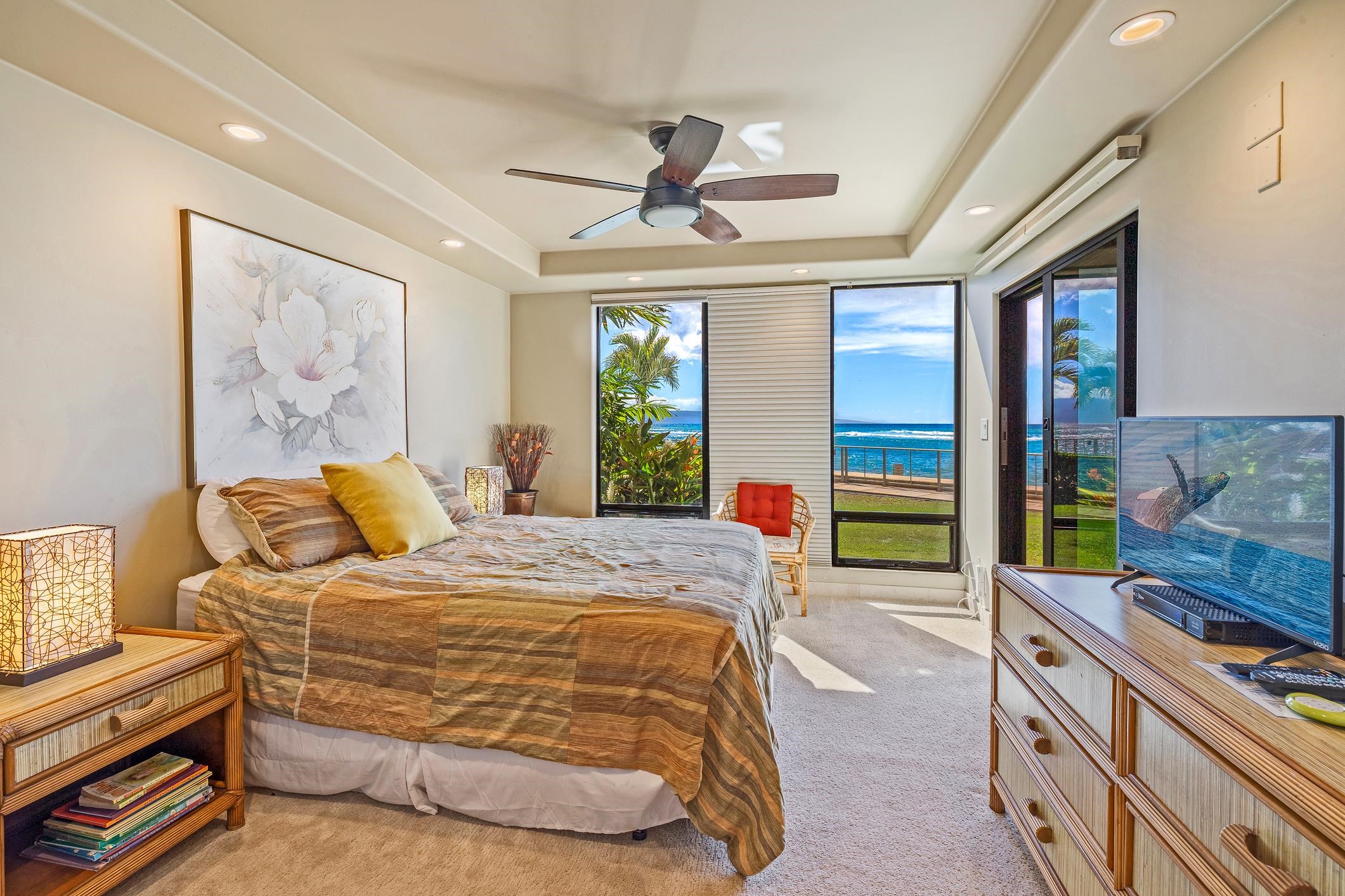4401 Lower Honoapiilani Road, Unit A103 Lahaina, HI 96761 - Photo 9 of 45 a bedroom with a bed dresser and a large window