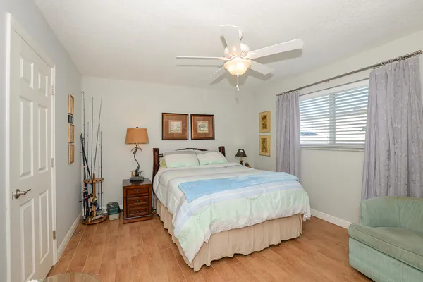 a bedroom with a large bed and a chandelier