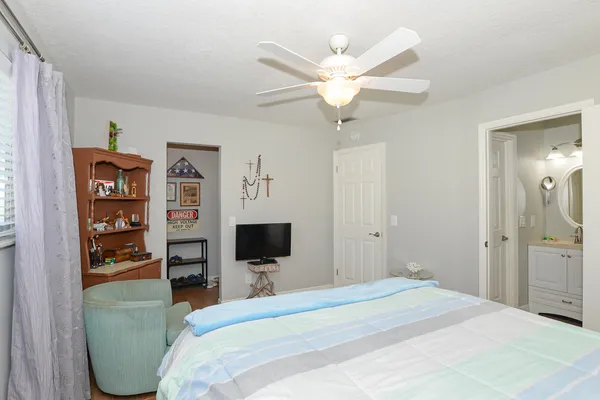 a bedroom with a bed and a flat screen tv