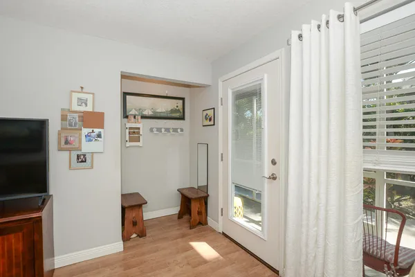 a view of a hallway with bathroom and wooden floor