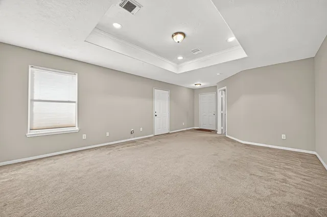 an empty room with windows and closet