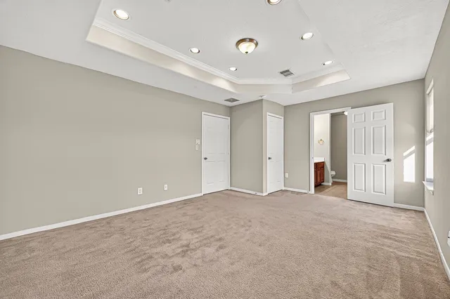 a white bath tub sitting next to a shower