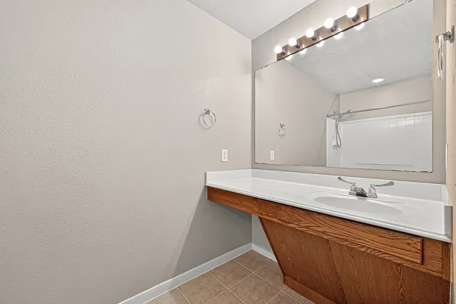 a bathroom with a tub a sink and shower