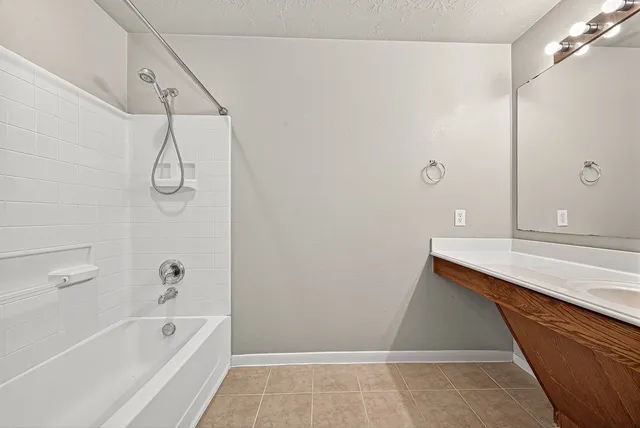 a bathroom with a bathtub and a shower