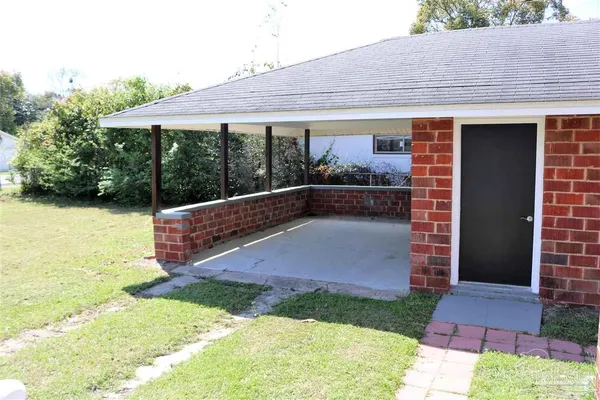 a backyard of a house with yard and outdoor seating